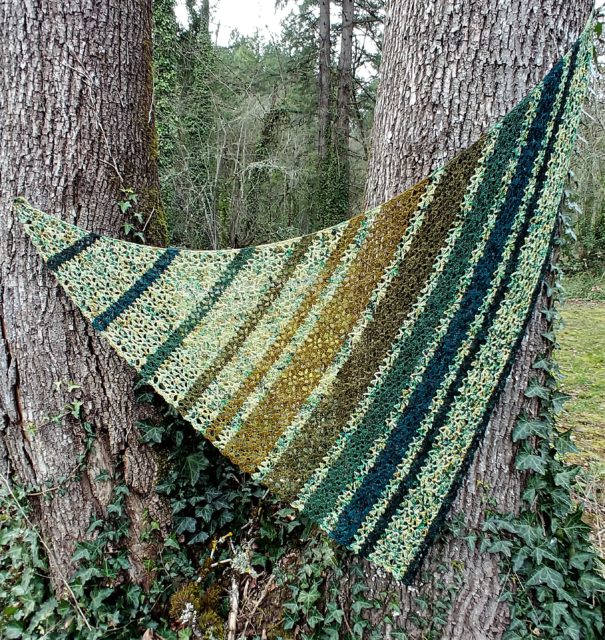 Ned's Dye-Pot triangular Shawl with speckled yarn alternated with solid minis in varying widths of stripes.